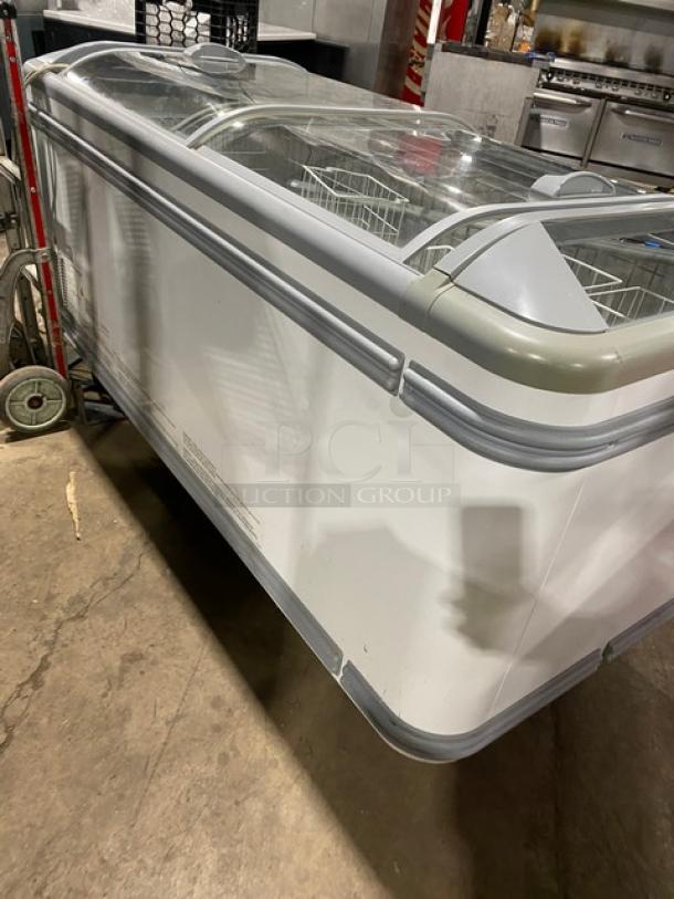 AHT Malta185 ice cream merchandiser, curved-top, white, with double glass sliding doors and poly-coated wired basket. Model SN: 34886700000006.