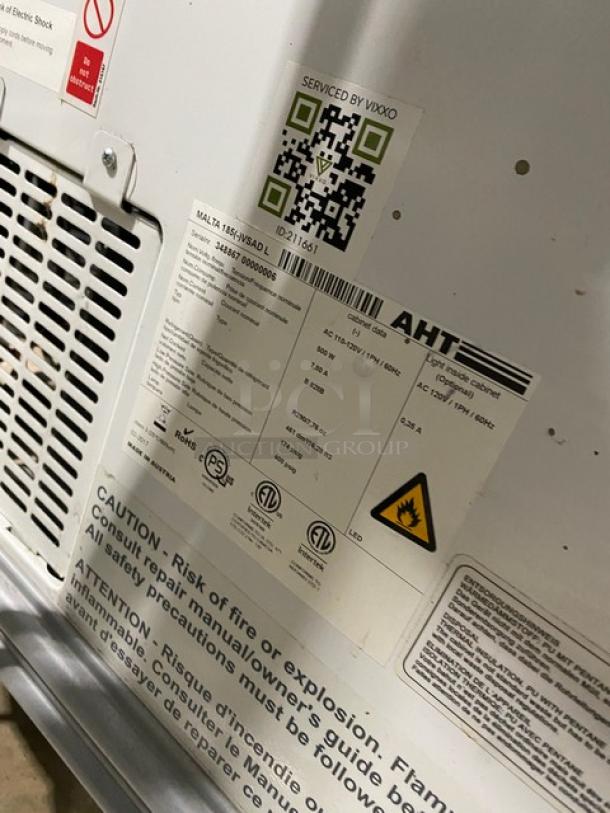 AHT Malta185 ice cream freezer, model label showing SN: 34886700000006, 110-120V, double glass sliding doors, white.