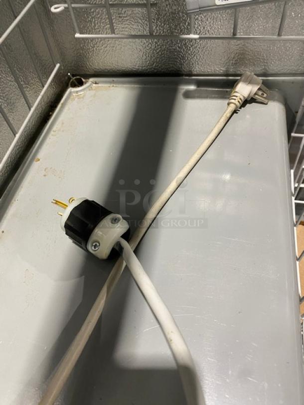 AHT Malta185 ice cream freezer plug and interior wiring detail, showcasing metal surface and poly-coated wire basket inside.