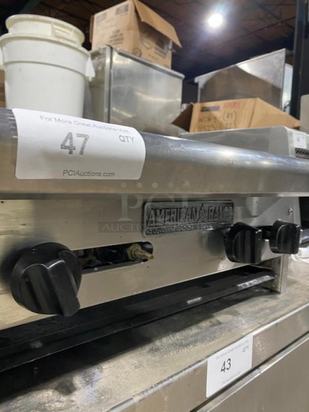 American Range stainless steel 4-burner commercial gas countertop range, used condition, visible brand logo and control knobs.