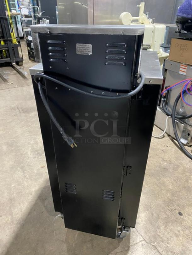 Cookshack Model 150 black electric smoker oven with digital control, 110V, on casters, showing rear view with power cord.