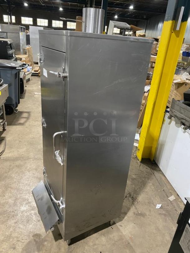 Commercial stainless steel gas-powered Chinese smoker oven on legs, in good condition. Features sturdy handles and a vented top, ideal for large-scale smoking tasks.