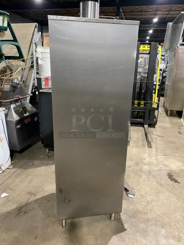 Commercial stainless steel gas-powered smoker oven on legs. Features durable construction; suitable for large-scale smoking needs.