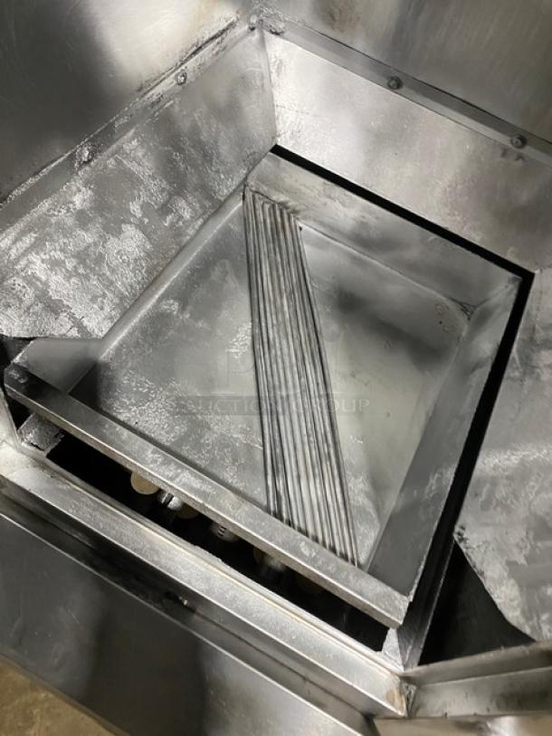 Commercial stainless steel gas-powered Chinese smoker oven, internal view, showing sturdy construction and smoke compartments.