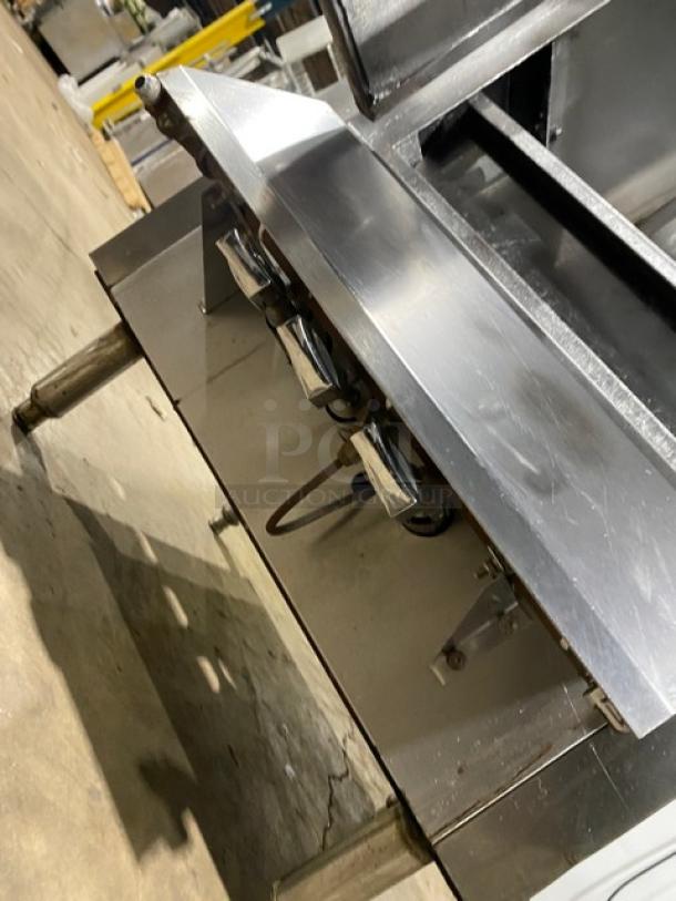 Commercial stainless steel gas-powered Chinese smoker oven, on legs, showing control knobs and gas connections, in good condition.