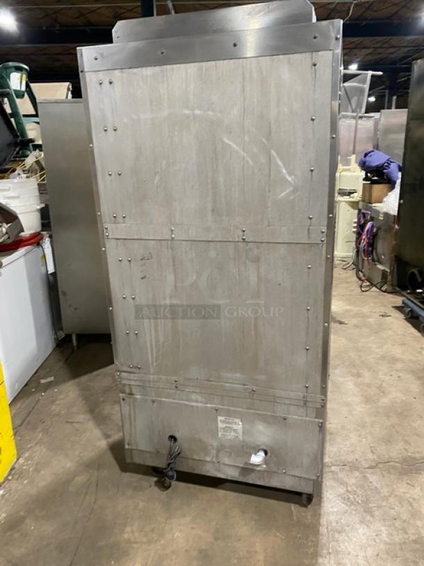 Southbend stainless steel gas-powered upright double deck broiler on casters, shown from the back in a warehouse setting.