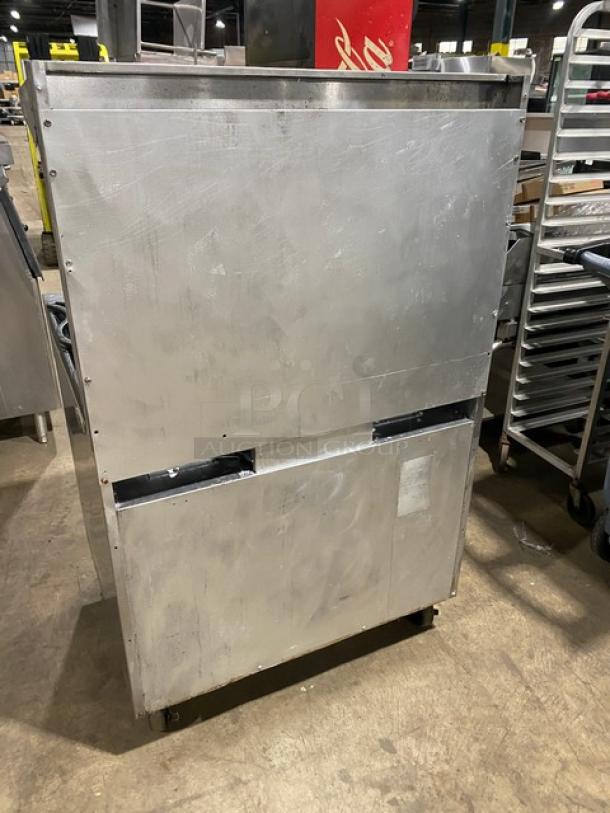 Southbend S36D commercial stainless steel 6-burner range/oven combo, natural gas, on casters, with back splash and overhead salamander shelf.