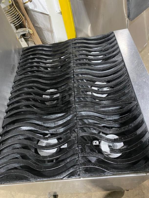 Southbend S36D stainless steel gas range with 6 non-clog wavy grates, overhead salamander shelf, and wired oven rack on casters.