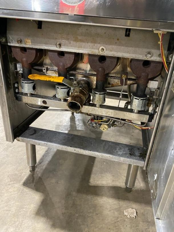 Keating Instant Recovery Series commercial stainless steel gas fryer, visible heating elements, on legs, includes backsplash and basket hanger.