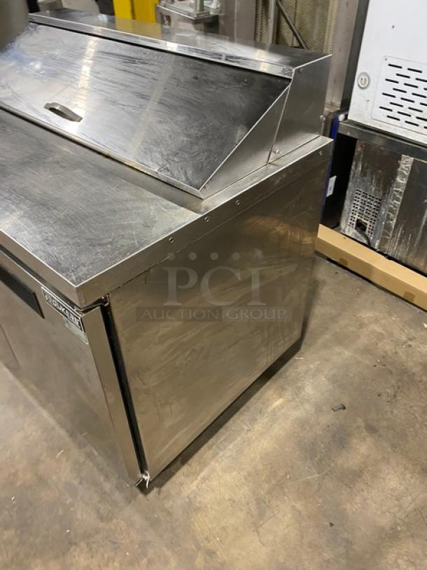 Dukers DSP48 stainless steel salad/sandwich prep table, Bain Marie style, with wired rack, on casters, 115V.