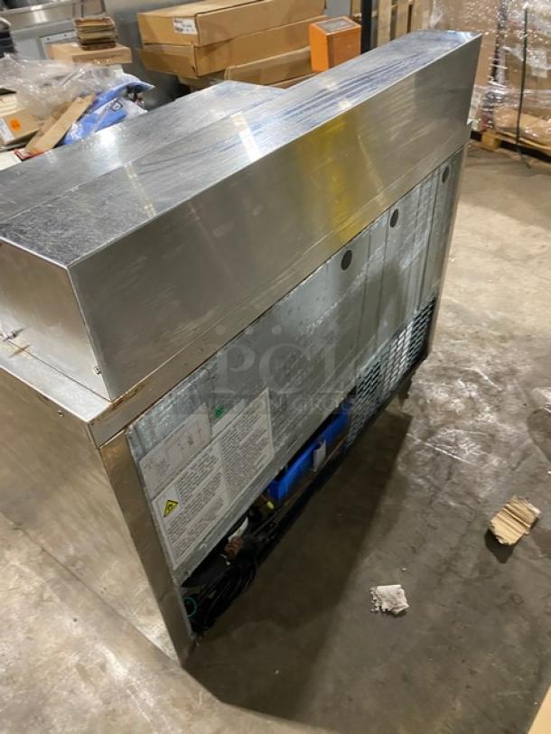 Dukers DSP48 stainless steel salad prep table, Bain Marie style, includes wired rack. Features include casters and 115V power.