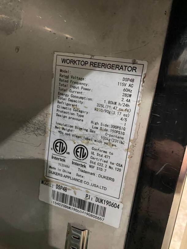 Dukers DSP48 stainless steel bain marie prep table, 115V, on casters, with wired rack. Model and serial number on label.