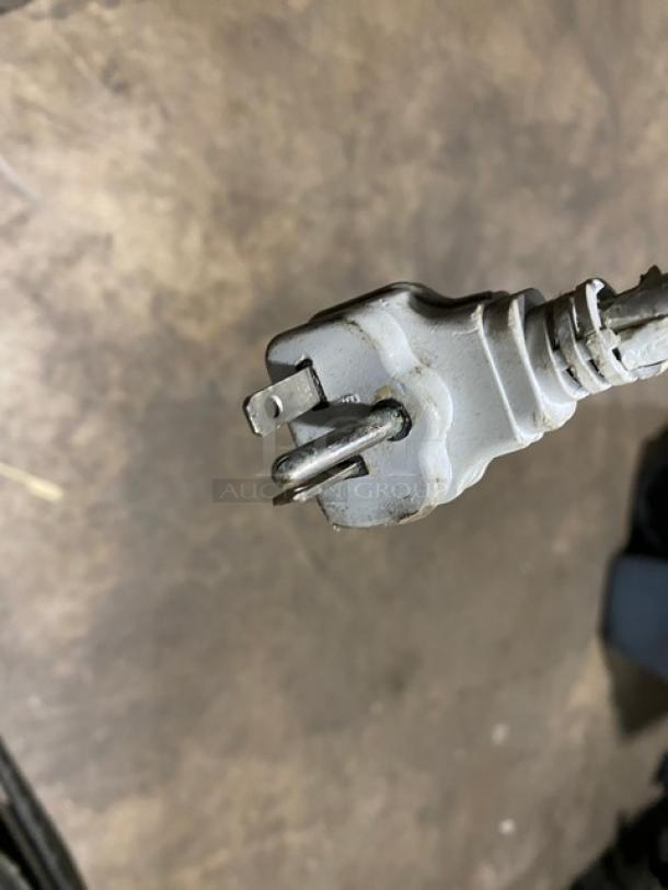 Close-up of electrical plug for Turbo Air Model TOM40MB refrigerated merchandiser. Plug appears functional.