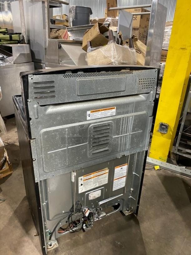 Amana Commercial gas range/oven combo, stainless steel/black, 4 burners, digital controls, wired oven rack, used condition.