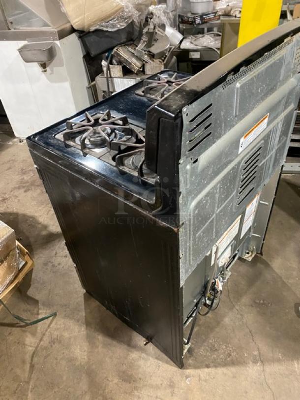 Amana stainless steel and black commercial 4 burner gas range/oven combo with digital controls and wired oven rack.