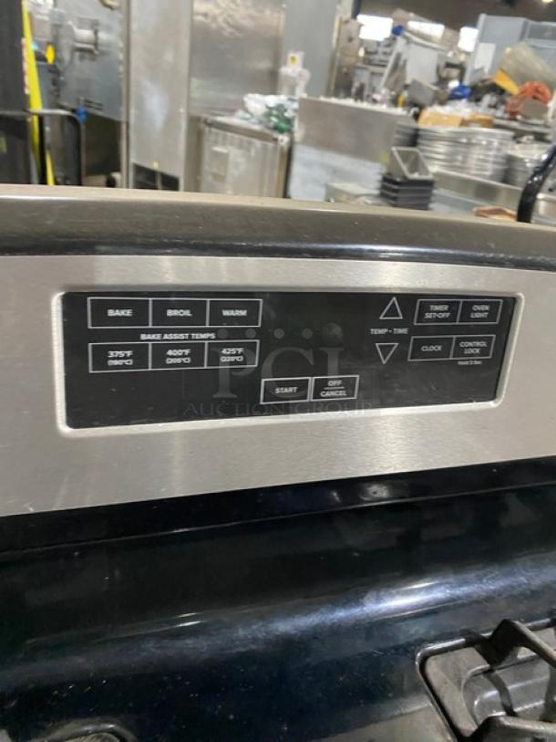 Amana Commercial 4-burner range/oven in stainless steel, black-coated finish. Features digital push-button controls and wired oven rack.