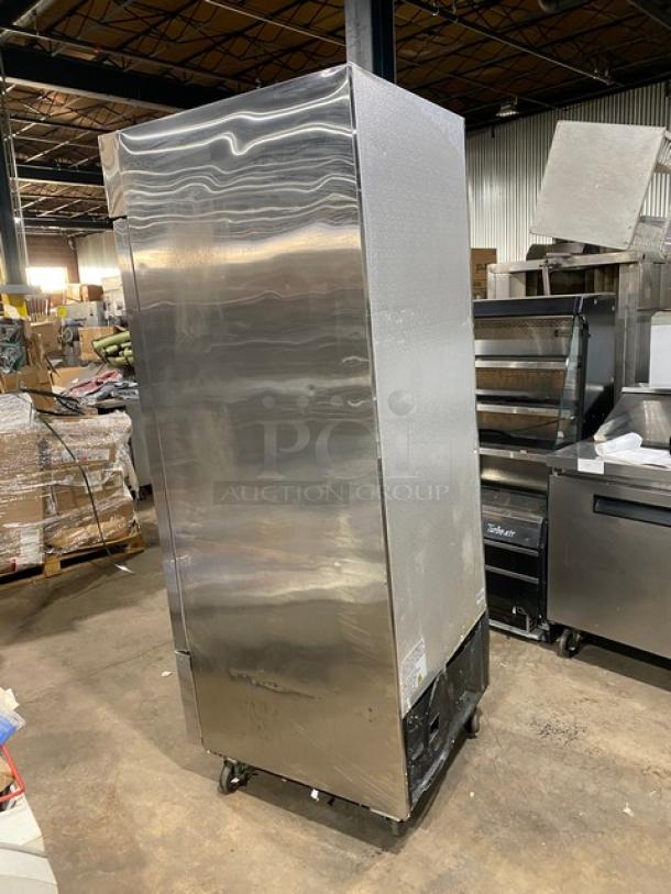 Universal commercial stainless steel reach-in freezer, single solid door, with poly-coated wired rack, on casters, in good condition.