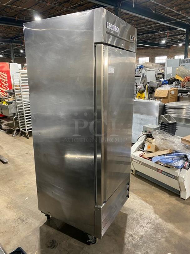 Universal stainless steel reach-in freezer with single solid door, poly-coated wire rack, on casters, in good condition.