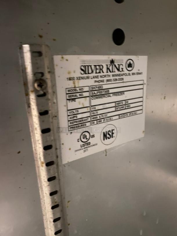 Silver King SKF48G label on stainless steel undercounter freezer, showing model, serial number SAJF69736B, 115V, NSF certified.