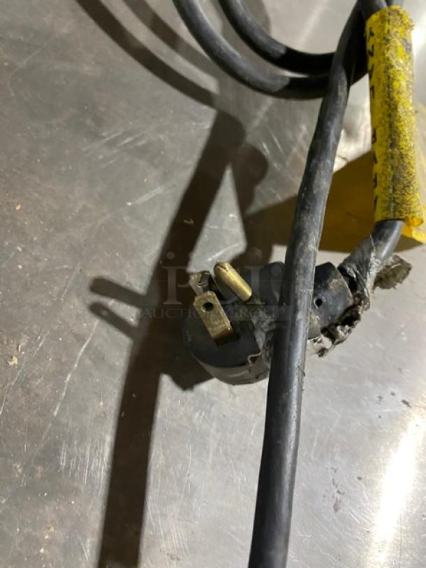 Power cord of a Silver King SKF48G freezer with visible wear.