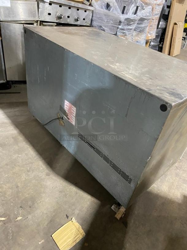 Silver King SKF48G stainless steel double glass swing door undercounter freezer. Visible wear, includes label with model info.