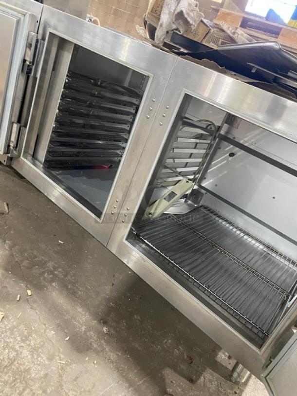 Traulsen UC2HT commercial stainless steel 2-door undercounter refrigerator, 69", built-in pan slide, chrome rack, on legs.