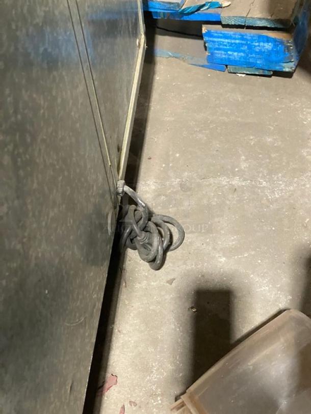 Traulsen UC2HT stainless steel 2-door undercounter refrigerator, 69", with built-in pan slide, chrome rack, visible power cord.