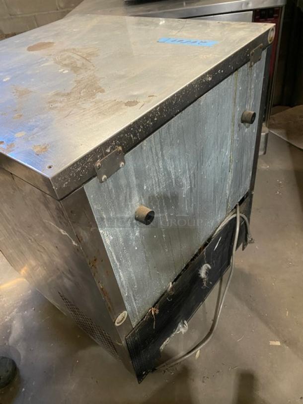 Delfield 406CA-DHL-DD1 stainless steel undercounter refrigerator, single door, coated wired rack, on casters, worn condition.