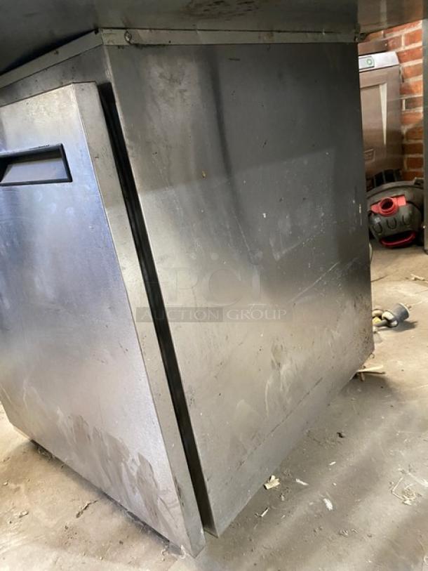 Delfield 406CA-DHL-DD1 stainless steel single door undercounter refrigerator on casters, shows signs of use.