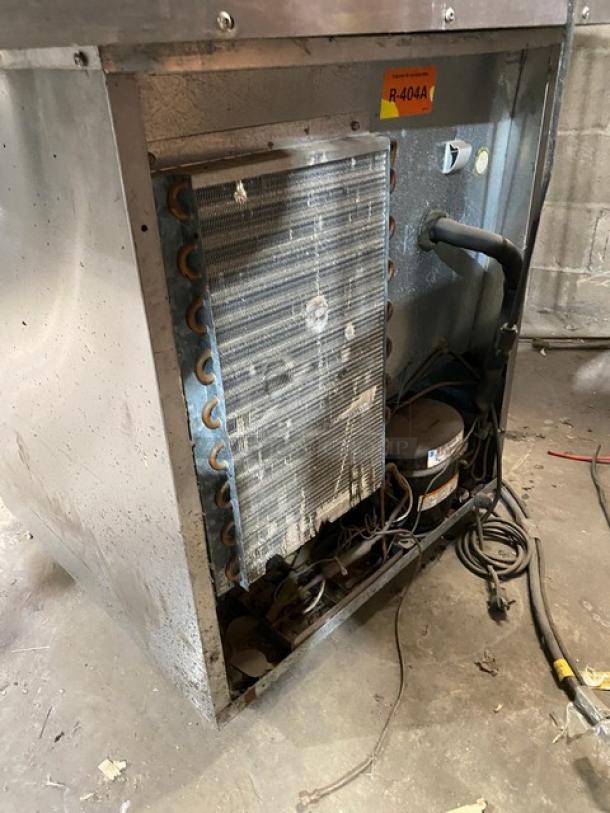 Delfield 406CADHLDD1 undercounter refrigerator, stainless steel, single door, visible internal components, R-404A refrigerant label.