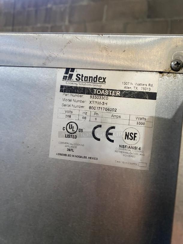 APW Wyott X*Treme Series stainless steel conveyor toaster, model XTRM3H. Features a 13" wide belt, 3" opening, and 208V 1 Phase power. CE and NSF certified, serial number 800071704002.