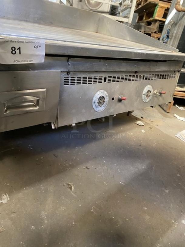 Keating commercial stainless steel gas griddle, countertop model with back and side splash, thermostatic control, on legs.