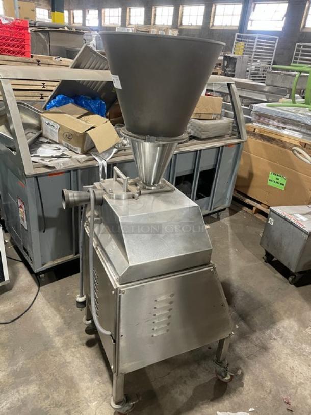 Commercial stainless steel electric vacuum stuffer/filler; free-standing, on casters, industrial-grade, used condition.