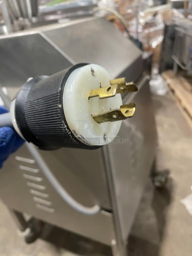 Commercial stainless steel electric vacuum stuffer/filler with casters, showing plug detail. Excellent condition.