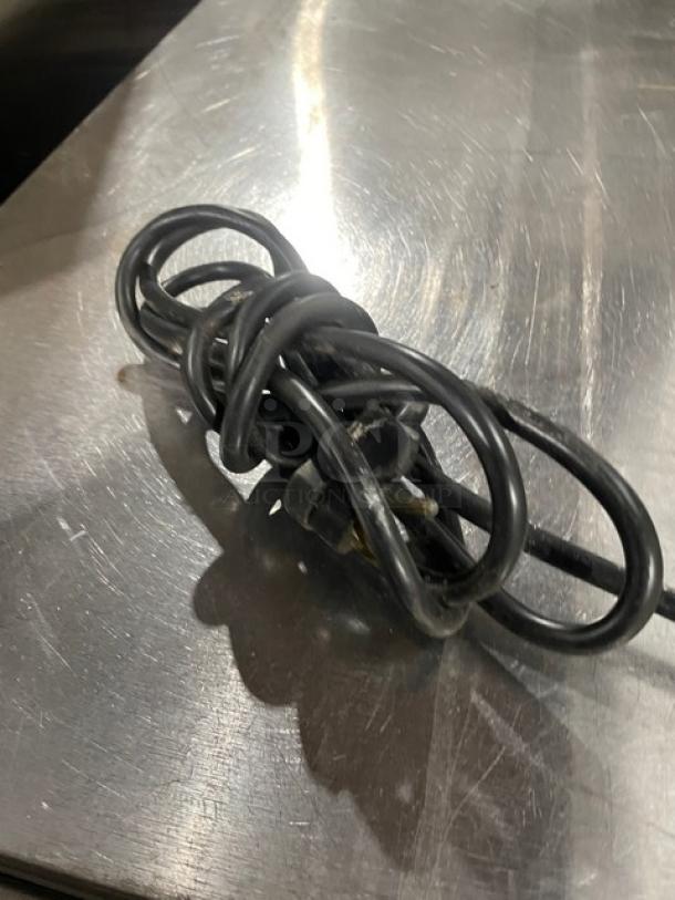 Coiled power cord of Beverage-Air UCR27Y refrigerator on stainless steel surface. Model: UCR27Y, SN: 7903537, 115V 1 Phase.