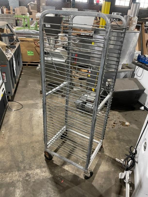 Channel commercial aluminum 36-pan end load rack with wire slides, on casters. Used condition. Visible in a warehouse setting.