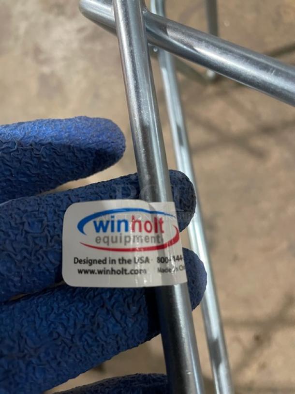 Winholt W-1014 commercial wired steel display stand, 10"x14", 500 lb capacity, on legs with label indicating USA design.