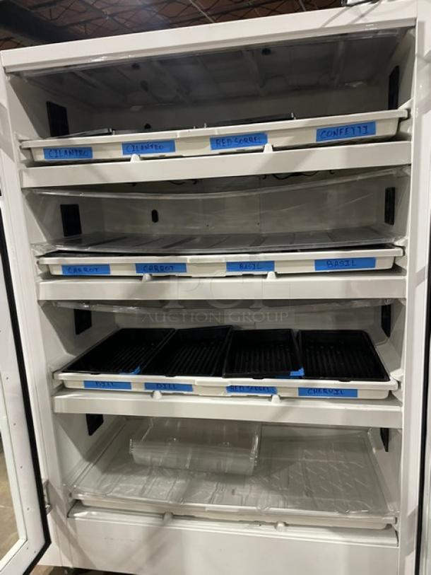 Urban Cultivator Commercial 001 indoor garden with double glass doors, labeled trays for herbs and microgreens, on casters.