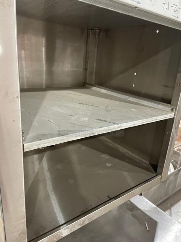 Krowne Royal 2100 Series stainless steel 2-tier underbar glass storage unit with drainboard and backsplash, model KR21GSB3.