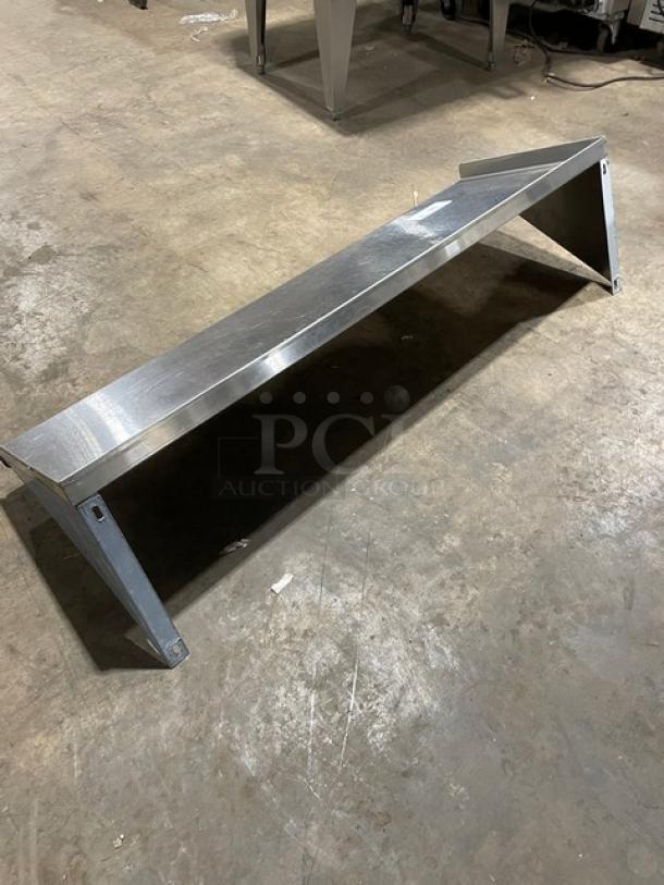 Commercial stainless steel wall-mount shelf with ticket/order holder. Rectangular, sturdy design, excellent condition.