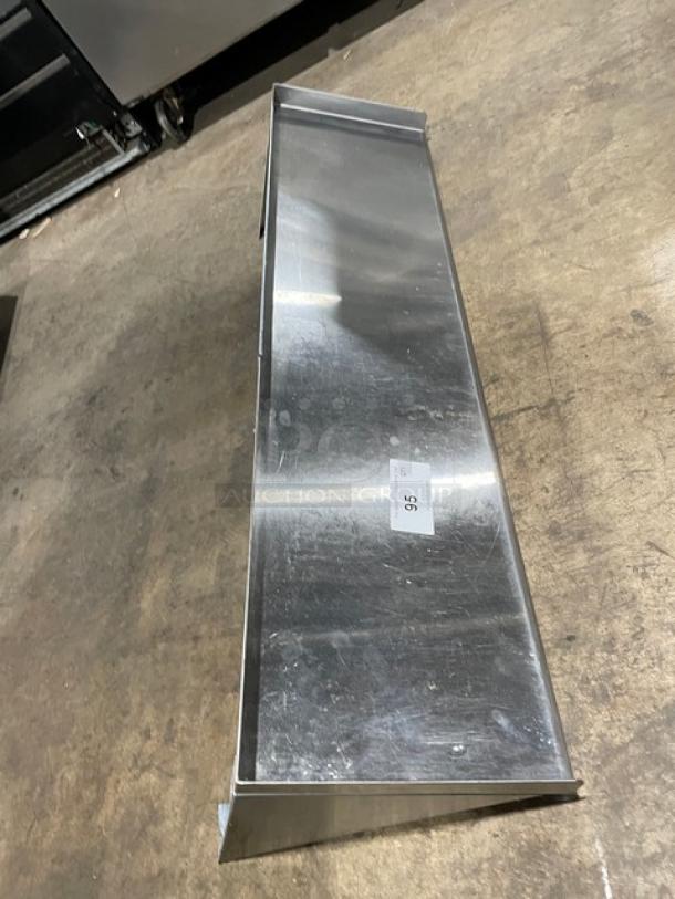 Commercial stainless steel rectangular wall-mount shelf, new condition, with label indicating size 36”.
