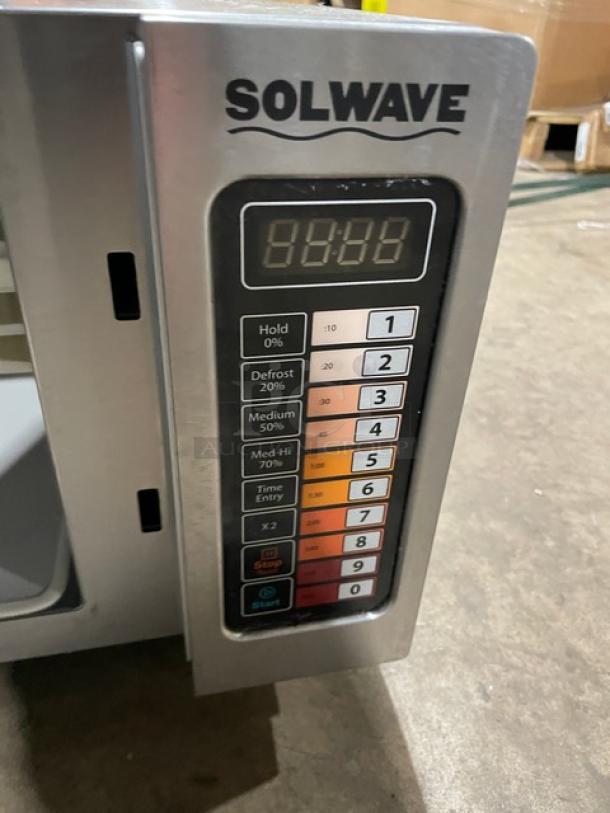 Solwave stainless steel digital countertop microwave, model 180MW1000SS, with control panel, 120V, on legs, late model 2023.