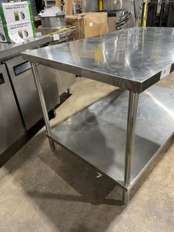 Commercial stainless steel flat worktop table with single undershelf and legs. Durable, ideal for kitchen use.