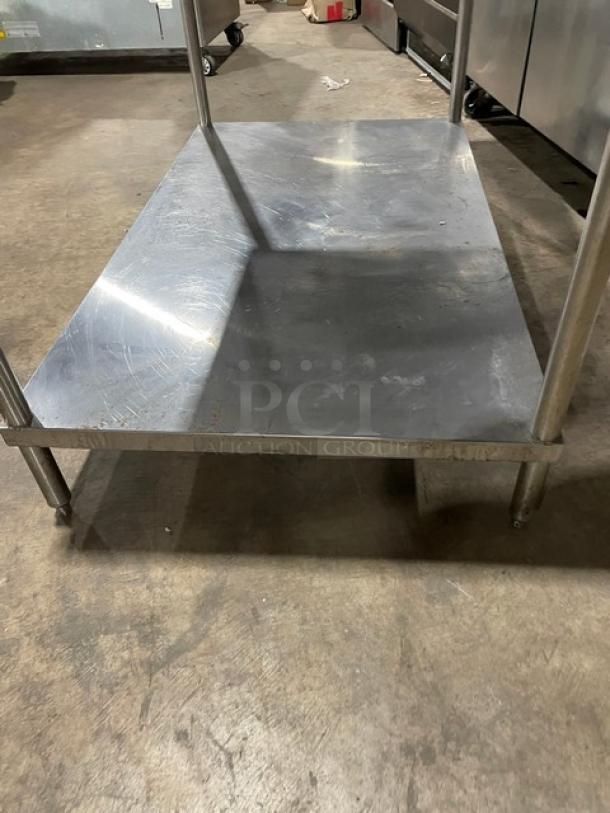 Stainless steel flat worktop table with single undershelf and sturdy legs. Used condition, ideal for commercial kitchen use.