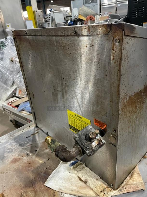 MagiKitch'n 624-H stainless steel char broiler, natural gas, commercial-grade, signs of use, visible warning labels.