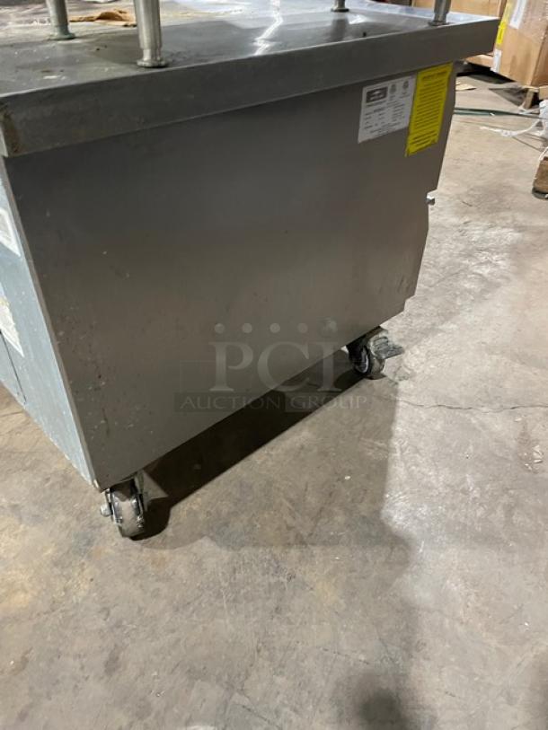 Arctic Air 62" Stainless Steel 2 Drawer Chef Base, Model ARCB60CZ, on casters, showing identification tags.