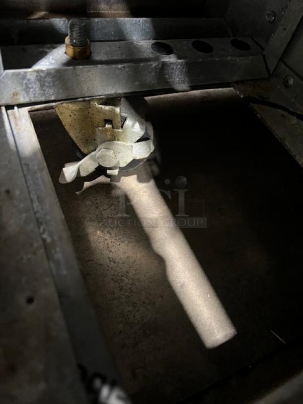 Interior view of Continental SW48N8 refrigerated bain marie prep table, showing metal components and wiring, in used condition.