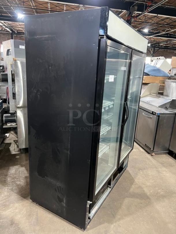 Maxx Cold MXM2-48F commercial black double glass swing door reach-in merchandiser freezer with poly coated wired racks.