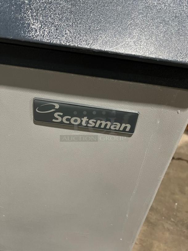 Scotsman commercial ice machine, model CME256AS-1H, stainless steel, electric, air-cooled, on legs, features brand label.