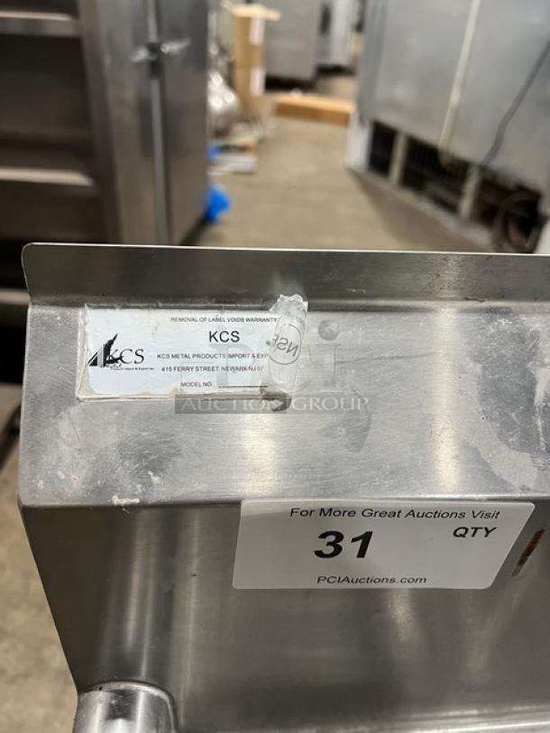 KCS commercial 3-compartment stainless steel sink with back splash, on legs. Label indicates KCS brand. Auction tag visible.